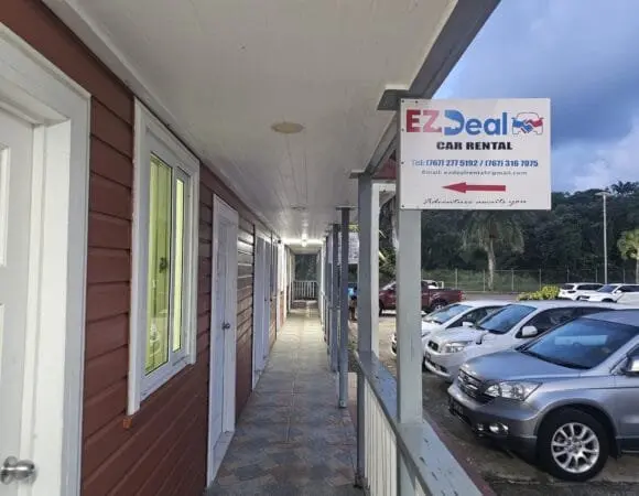 Vehicles parked beside the EZ Deal Car Rental office